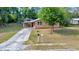 Charming single-story home with a covered carport and a well-maintained lawn at 1322 Ne 53Rd St, Ocala, FL 34479