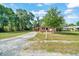 One-story home featuring a long driveway, and a lush green lawn at 1322 Ne 53Rd St, Ocala, FL 34479