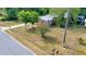 Side angle of a single-story house with a well-manicured lawn and lush trees surrounding the property at 1322 Ne 53Rd St, Ocala, FL 34479