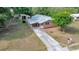 Charming single-story home with a well-maintained lawn, a long driveway, and mature landscaping at 1322 Ne 53Rd St, Ocala, FL 34479
