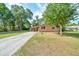 Exterior view of a cozy single-story home featuring a long driveway at 1322 Ne 53Rd St, Ocala, FL 34479