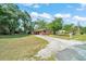 Exterior shot of a one-story home with an expansive front yard and paved driveway at 1322 Ne 53Rd St, Ocala, FL 34479
