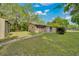 Exterior view of single-story home and shed with brick walkway on grassy lot at 1322 Ne 53Rd St, Ocala, FL 34479