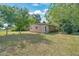 Side angle view of a one-story home with a well-maintained lawn at 1322 Ne 53Rd St, Ocala, FL 34479