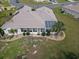 Aerial rear view of the house displaying solar panels and landscaped backyard, perfect for sunny Florida living at 13863 Se 85Th Cir, Summerfield, FL 34491