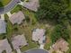 Rooftop view of a home showcasing solar panels and a lush surrounding landscape, perfect for eco-conscious buyers at 13863 Se 85Th Cir, Summerfield, FL 34491