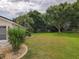 Expansive backyard featuring a lush lawn, mature trees, and garden beds, offering a serene outdoor space at 13863 Se 85Th Cir, Summerfield, FL 34491