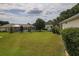 Backyard with mature trees, green lawn, and other houses at 13863 Se 85Th Cir, Summerfield, FL 34491