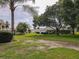 Backyard with mature trees, green lawn, and privacy, creating a park-like setting at 13863 Se 85Th Cir, Summerfield, FL 34491
