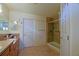 Bathroom featuring double vanity, tile flooring, a glass shower, and neutral walls at 13863 Se 85Th Cir, Summerfield, FL 34491