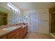 Bathroom with double vanity, tile flooring, neutral walls, and a glass-enclosed shower at 13863 Se 85Th Cir, Summerfield, FL 34491
