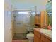 Clean bathroom with a spacious shower, glass doors, and built-in shelves at 13863 Se 85Th Cir, Summerfield, FL 34491