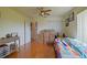 Bright bedroom with hardwood floors, a colorful quilt, and ample closet space at 13863 Se 85Th Cir, Summerfield, FL 34491