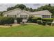 Beautiful home with manicured landscaping, mature shrubs, and well maintained front yard at 13863 Se 85Th Cir, Summerfield, FL 34491