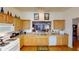 Cozy kitchen with wooden cabinets, white appliances, and a sunny breakfast bar at 13863 Se 85Th Cir, Summerfield, FL 34491