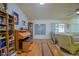 Comfortable living room with hardwood floors, vaulted ceiling, and an open layout at 13863 Se 85Th Cir, Summerfield, FL 34491