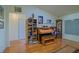 Inviting living room with hardwood floors, bookshelves, and ample natural light at 13863 Se 85Th Cir, Summerfield, FL 34491
