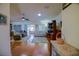 Inviting living room featuring hardwood floors, ceiling fan, and natural light perfect for relaxing and entertaining at 13863 Se 85Th Cir, Summerfield, FL 34491
