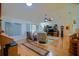 Spacious living room featuring hardwood floors, vaulted ceiling, and plenty of natural light at 13863 Se 85Th Cir, Summerfield, FL 34491