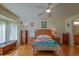 Inviting bedroom suite with hardwood floors, a sunny bay window, and ensuite bathroom, offering a private retreat at 13863 Se 85Th Cir, Summerfield, FL 34491