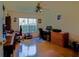 Functional home office with hardwood floors, a ceiling fan, and multiple workstations at 13863 Se 85Th Cir, Summerfield, FL 34491
