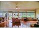 Sunroom with large windows, tile flooring, and a comfortable seating area at 13863 Se 85Th Cir, Summerfield, FL 34491