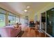Bright sunroom with tile flooring, large windows, and a ceiling fan at 13863 Se 85Th Cir, Summerfield, FL 34491