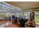 Bright sunroom with tile flooring, large windows, and multiple sewing machines at 13863 Se 85Th Cir, Summerfield, FL 34491
