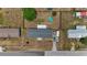 An aerial view of a home with a pool, fenced yard and driveway parking at 14276 Se 61St Ave, Summerfield, FL 34491