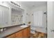 Nautical-themed bathroom with wood-look flooring, wooden vanity, and beachy decor at 14276 Se 61St Ave, Summerfield, FL 34491