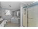 Bathroom featuring a glass enclosed shower, bathtub, toilet, and vanity at 14276 Se 61St Ave, Summerfield, FL 34491