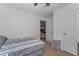 Modest bedroom with neutral walls, carpet, fan, and adjacent doorway to other room in home at 14276 Se 61St Ave, Summerfield, FL 34491