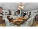 Dining area open to kitchen, featuring stylish chandelier and seating for six at 14276 Se 61St Ave, Summerfield, FL 34491