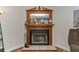 Cozy fireplace with decorative mantle, providing warmth and charm to the home at 14276 Se 61St Ave, Summerfield, FL 34491