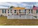 Charming front porch featuring shade and a white railing, creating a relaxing outdoor space at 14276 Se 61St Ave, Summerfield, FL 34491
