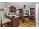 A cozy kitchen with brown cabinets, stainless steel appliances, and a breakfast bar at 14276 Se 61St Ave, Summerfield, FL 34491