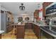 Open kitchen showcasing brown cabinets, stainless steel appliances, and access to the dining room at 14276 Se 61St Ave, Summerfield, FL 34491
