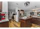An open kitchen area showcasing brown cabinets and stainless steel appliances at 14276 Se 61St Ave, Summerfield, FL 34491