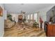 Open-concept living room featuring wood floors, fireplace, and lots of seating at 14276 Se 61St Ave, Summerfield, FL 34491