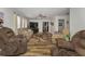 A living room with wood floors and a cozy fireplace, perfect for gatherings at 14276 Se 61St Ave, Summerfield, FL 34491