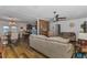 Bright and airy living room with hardwood floors, ceiling fan, open to dining area and kitchen at 14276 Se 61St Ave, Summerfield, FL 34491