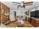Comfortable living room with wood floors, ceiling fan, and cozy seating arrangement at 14276 Se 61St Ave, Summerfield, FL 34491