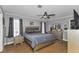 A spacious main bedroom with gray walls, carpet floors, and large furniture at 14276 Se 61St Ave, Summerfield, FL 34491