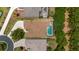 An aerial view shows a home with a screened pool, a paved driveway, and mature landscaping at 1429 Sw 160Th Ln, Ocala, FL 34473