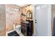 Half bathroom with a black granite countertop, a vessel sink, and textured walls at 1429 Sw 160Th Ln, Ocala, FL 34473
