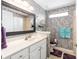 Stylish bathroom with a marble countertop, large mirror, and colorful textured wall at 1429 Sw 160Th Ln, Ocala, FL 34473