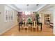 Dining room with a modern chandelier, accent wall, and seating for six at 1429 Sw 160Th Ln, Ocala, FL 34473