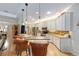 Open kitchen with granite countertops, stainless steel appliances, and bar seating at 1429 Sw 160Th Ln, Ocala, FL 34473