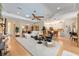 Open-concept living room with a white sofa, ceiling fan, and bar seating at the kitchen counter at 1429 Sw 160Th Ln, Ocala, FL 34473