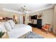 Bright main bedroom featuring tray ceilings, natural light, and an ensuite bathroom entrance at 1429 Sw 160Th Ln, Ocala, FL 34473